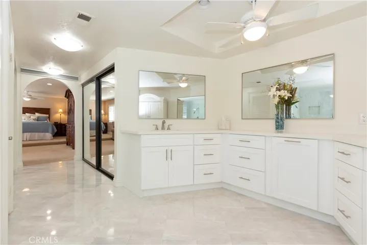 Sparkling primary bathroom and closets.