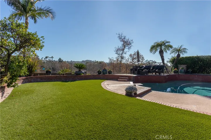Spacious turf bordered by flower beds.