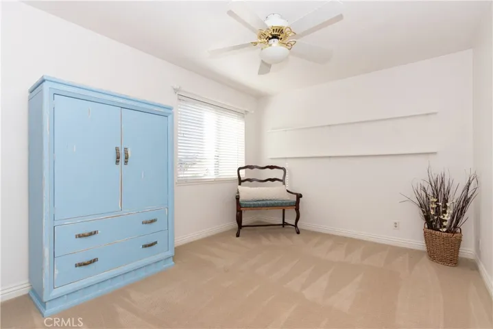 Secondary bedroom with a ceiling fan.