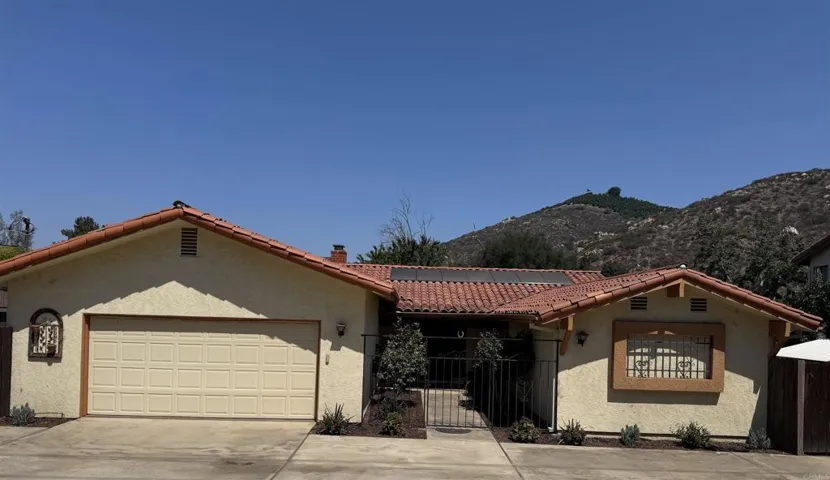 Front of house with circular driveway & courtyard.