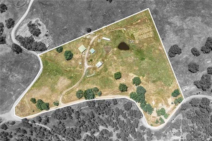 House is at top of property (bottom right corner) with out buildings below (upper middle) and trailer and greenhouse structures beyond (upper right)
