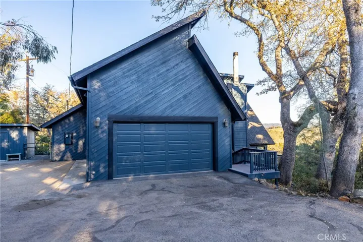 The attached 2 car garage is oversized with shelving, cabinets and a workbench. There is also a storage shed to the side.