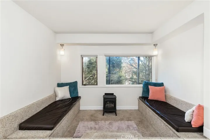 Past the murphy bed is a sunken hang out area complete with built-in benches and gas​​‌​​​​‌​​‌‌​​‌​​​‌‌​​​‌​​‌‌​​‌‌​​‌‌​​​​ stove.