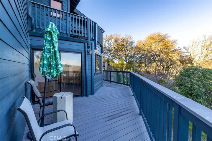 The deck wraps around the entire back of the home. The sliding glass door leads into the dining area.