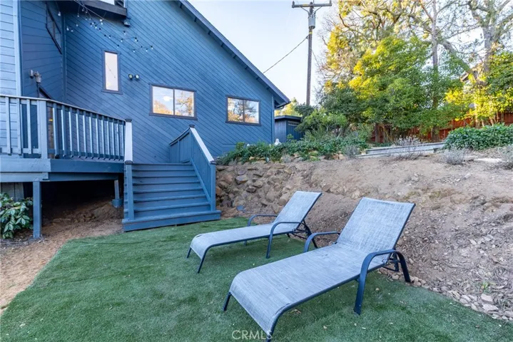 Level area directly off the stairs from the deck. Perfect location for an above ground pool, power located under the deck.