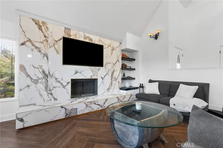 Anchoring the living room is a wood burning fireplace with exquisite surround.