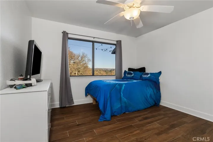 Bedroom 2 offers wood tile floors, ceiling fan and radiant floor heating.