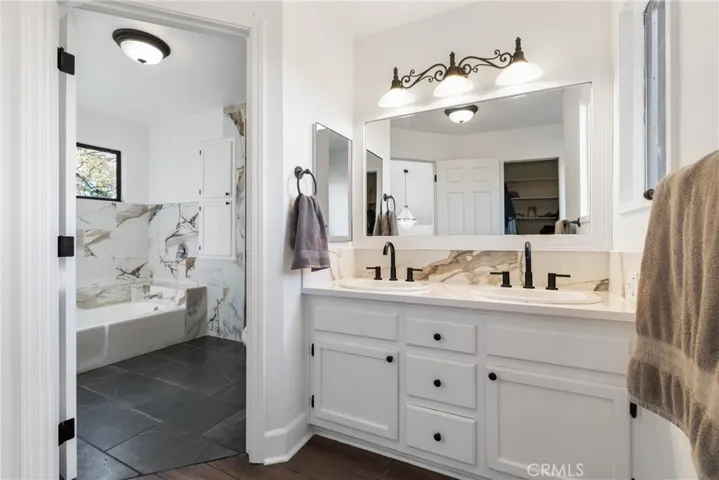 The ensuite bathroom has a separate sink area and bathing area. There is also a walk in closet with organizers.