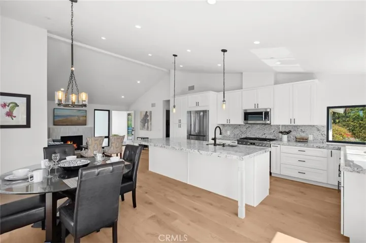  High-end Bosch appliances, including a built-in 6-burner range, complete the space seamlessly.
