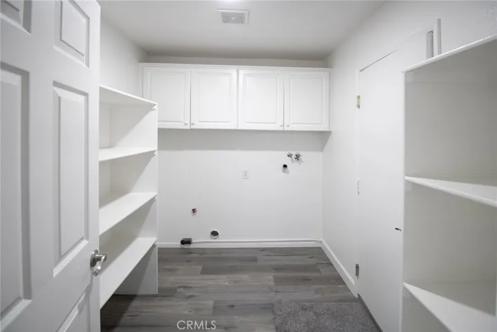 Convenient indoor laundry room with dedicated space for washer and dryer, offering practicality and everyday comfort.