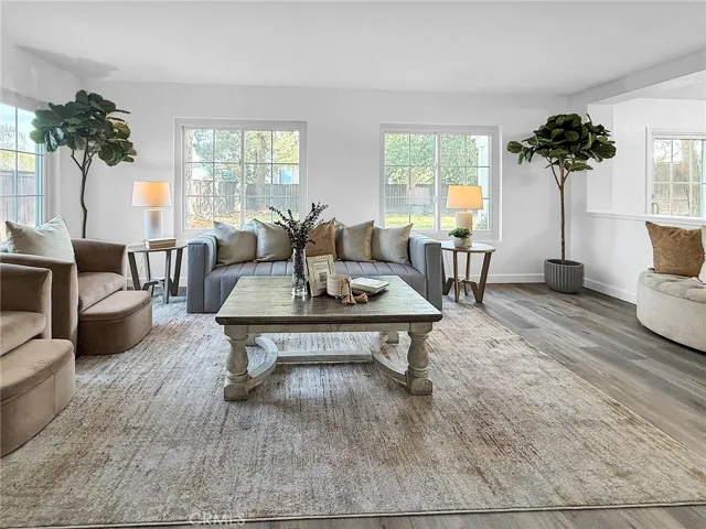 Bright and spacious living room with an open layout, abundant natural light, and a welcoming atmosphere for relaxing or entertaining.