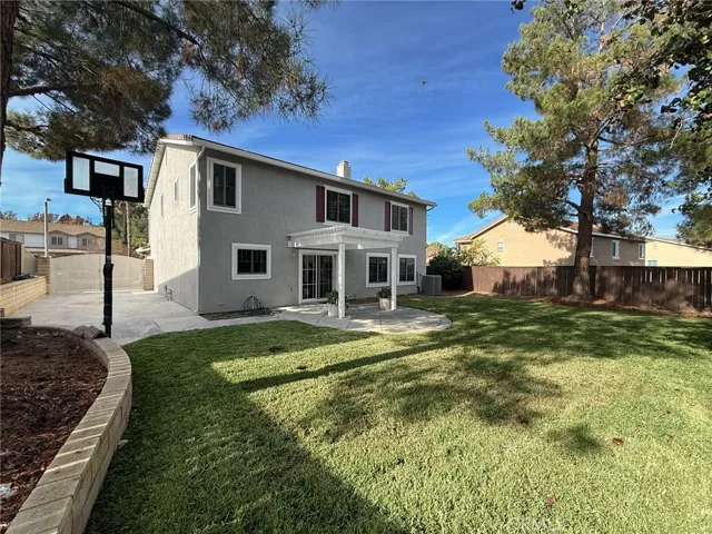 View of the backyard highlighting the RV parking area with a 35-ft slab and full hookups, with Basketball court.