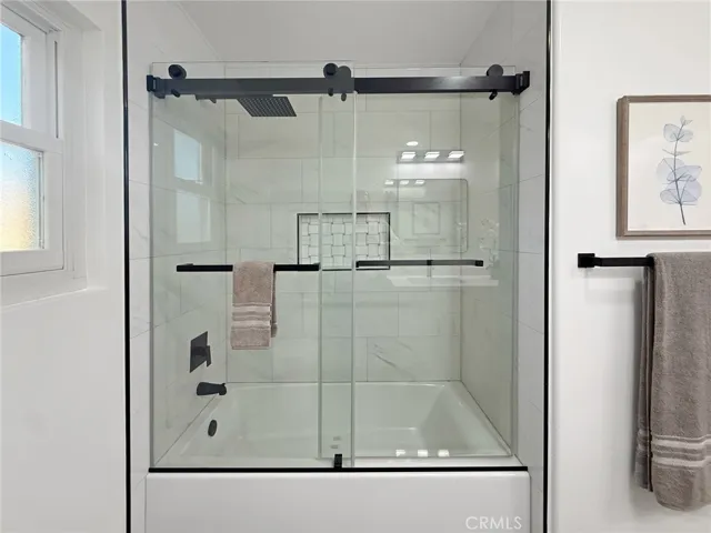 Bathroom featuring a combined shower and bathtub, offering versatility and convenience for daily routines or relaxing soaks.