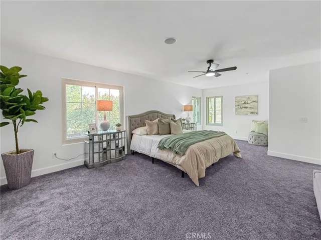 Spacious primary bedroom with a serene retreat area, offering a relaxing private space filled with natural light and comfort.
