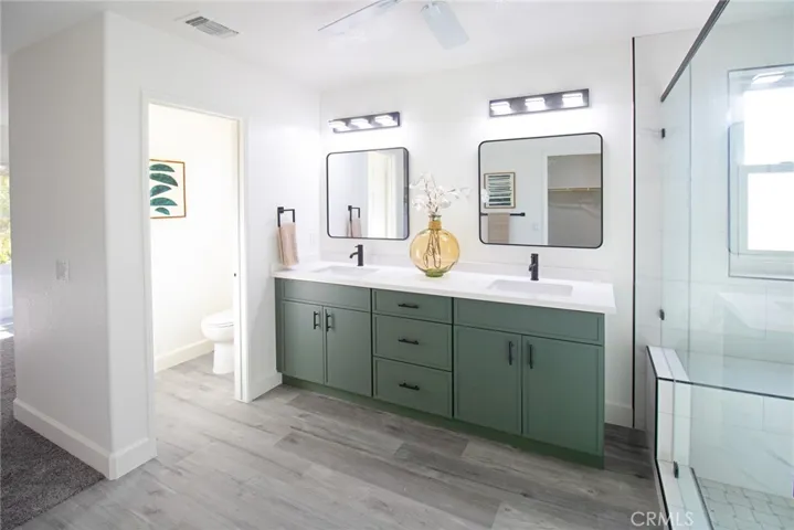 Primary bathroom with a private toilet area, modern finishes, and a spacious, spa-like design for comfort and privacy.