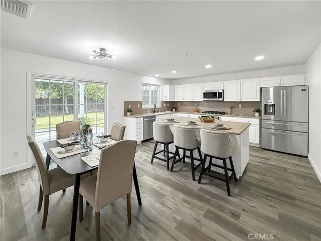 Updated kitchen and nook area featuring a functional layout, ample natural light, and a comfortable space ideal for everyday meals and gatherings.