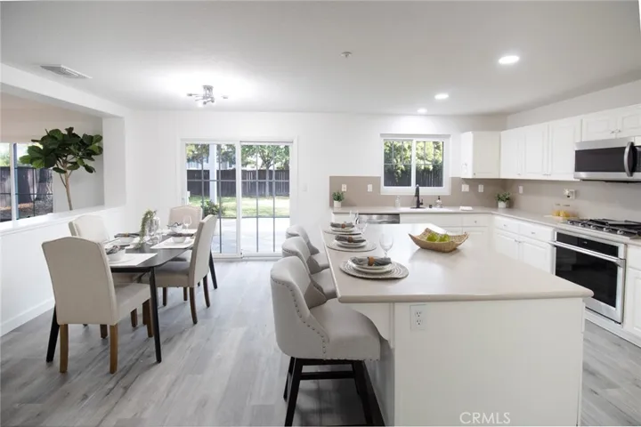 Spacious kitchen island and nook area offering a functional layout, great flow, and an inviting space for casual dining and entertaining.