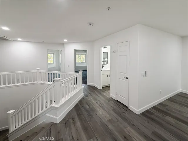 Bright upstairs hallway with open flow, connecting bedrooms and living spaces while offering natural light and a welcoming feel.