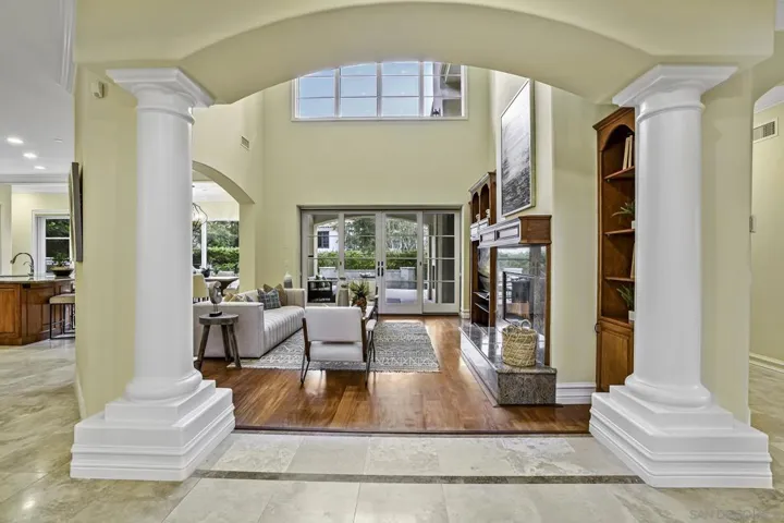 Cozy family room open to kitchen and leads to outdoor family room with fireplace.