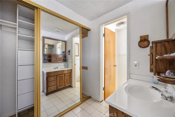 DRESSING AREA IN PRIMARY SUITE. DOOR LEADS TO TOILET AND SHOWER