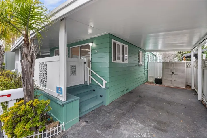 large covered carport with storge locker