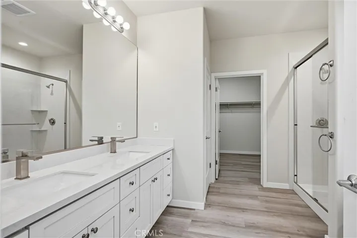 Primary bath vanity has two sinks.
