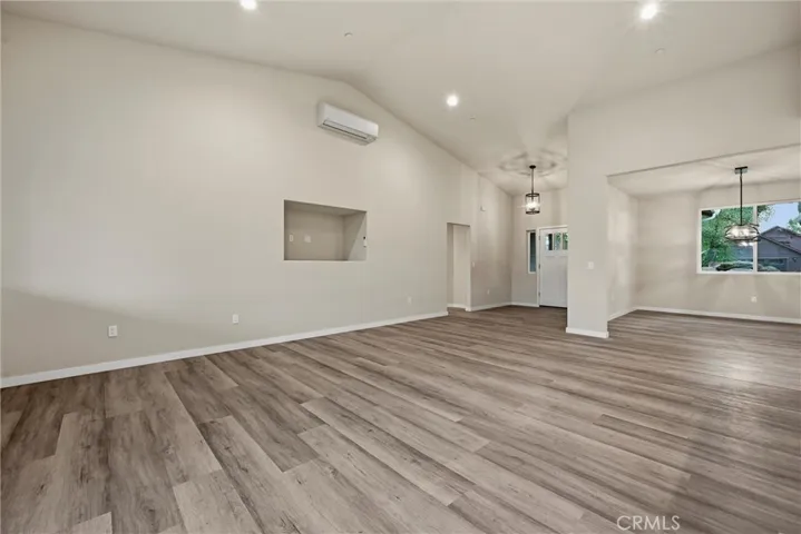 Living and dining area from sliding door looking toward front entrance.