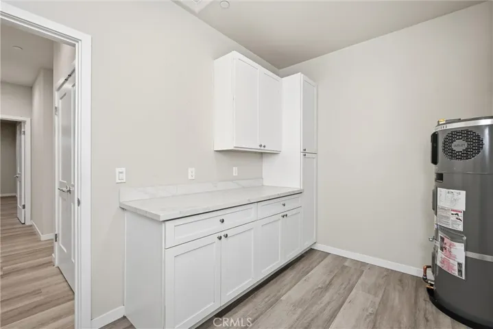 Laundry / mudroom has lots of cabinetry.