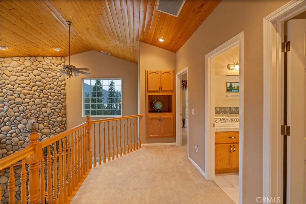 upper level guest bathroom, primary suite and two guest bedrooms