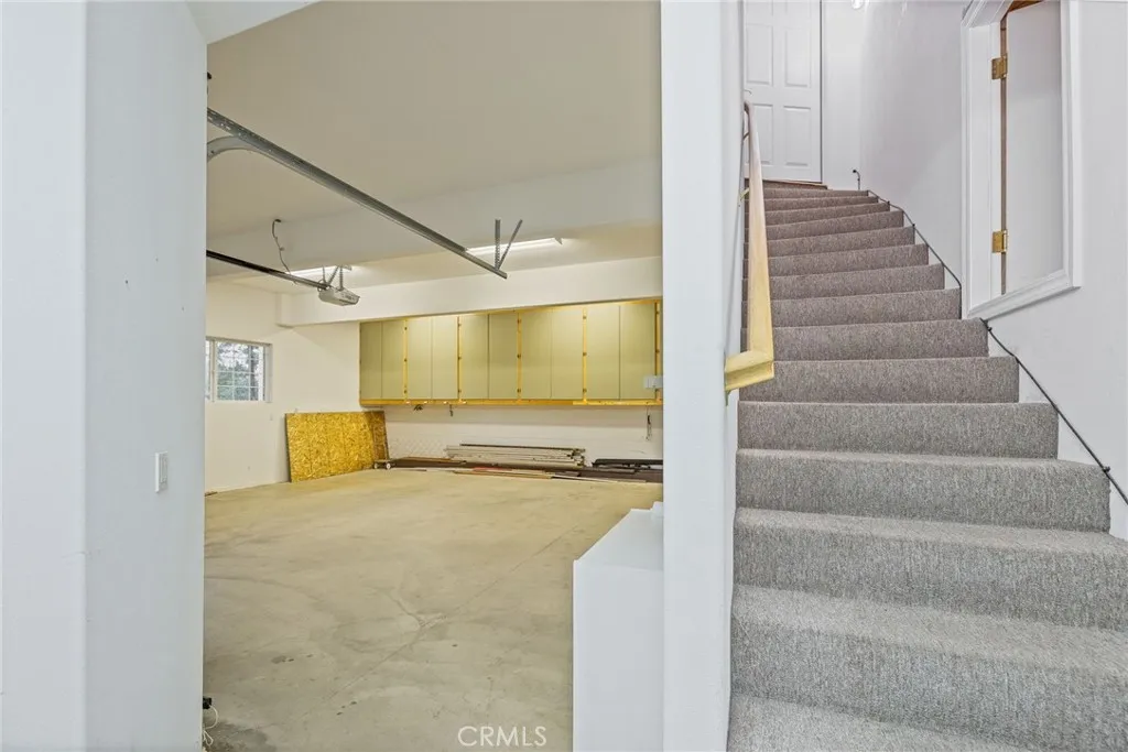 stairs to garage, storage area off stairs