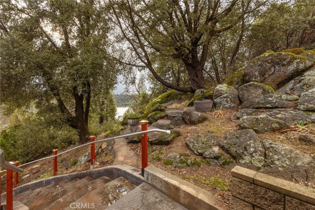 stairs leading to garage level distant lake views