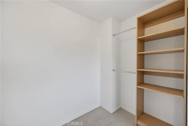 Open walk-in closet with built-in shelving