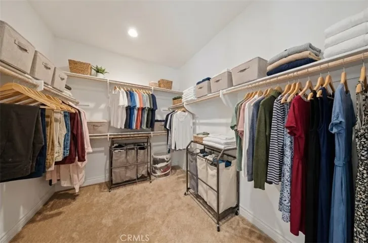 Large, spacious walk in closet in primary bedroom - Virtually Staged