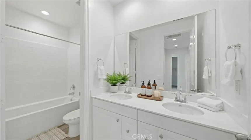 Second full bathroom with shower/tub combo. Dual sink - Virtually Staged