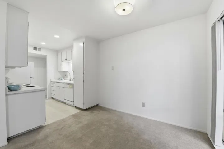 Dining space right off the kitchen. Fresh paint and new lighting.