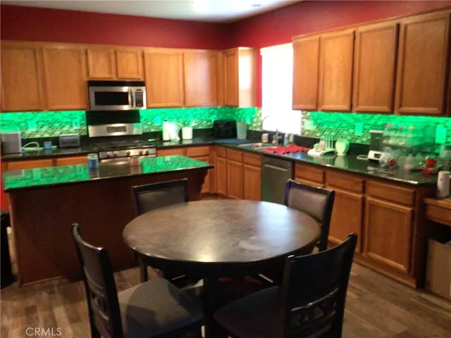 Kitchen with aisle and dining area