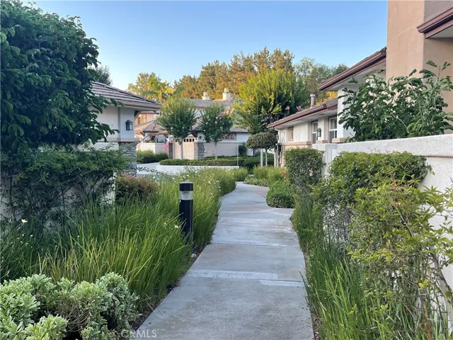 Home in distance walks this path to stairs for dining and membership based club amenities