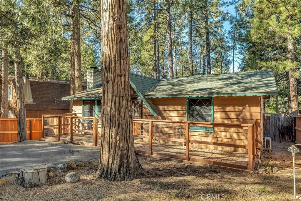 Daytime house picture with lots of mature trees for shade