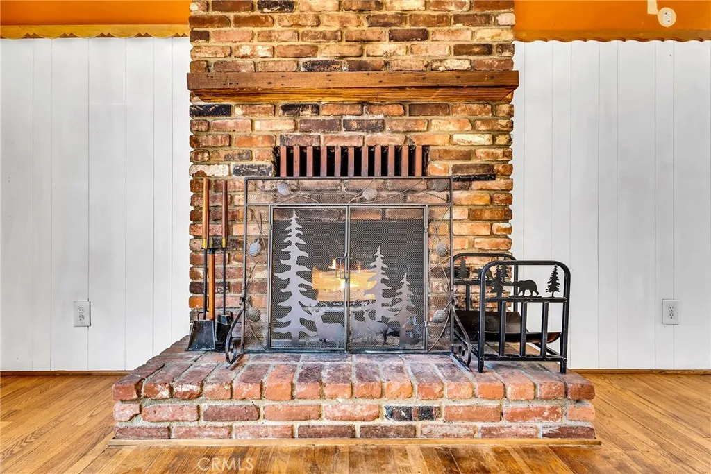 Beautiful brick fireplace with lovely fire screen