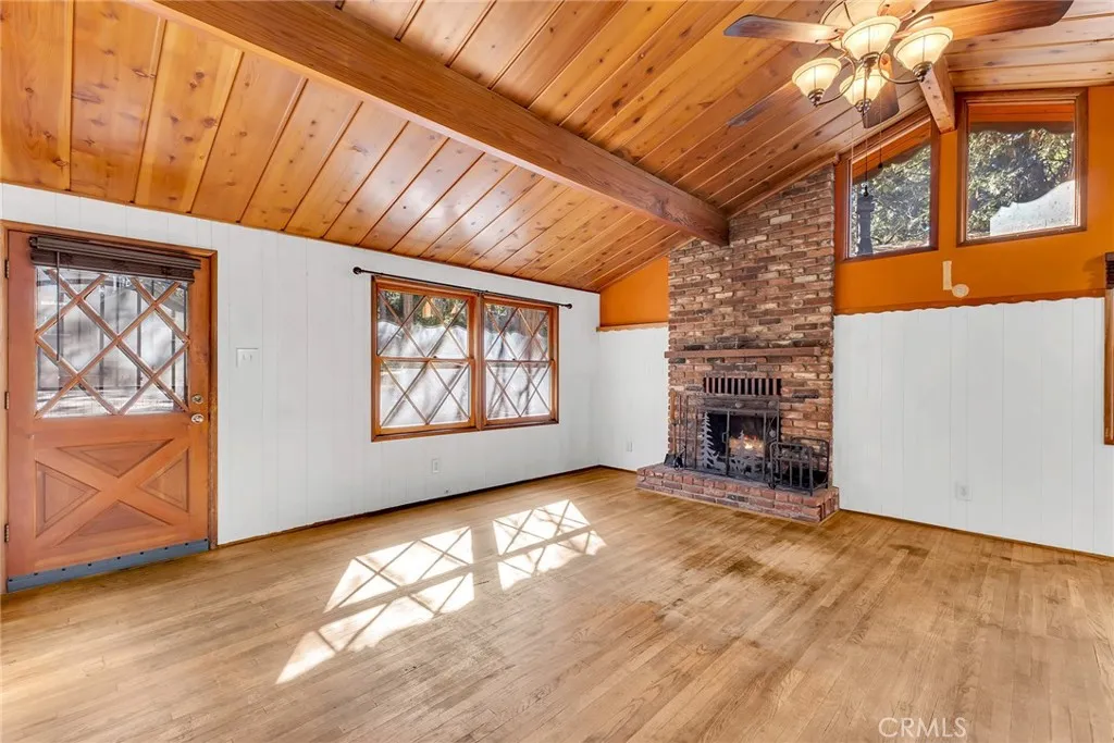 Lovely ceilings and living area with warm brick fireplace