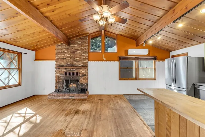 Living room with brick fireplace and hardwood floors