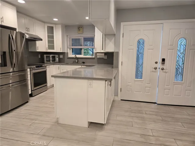 Entry adjacent to customized kitchen