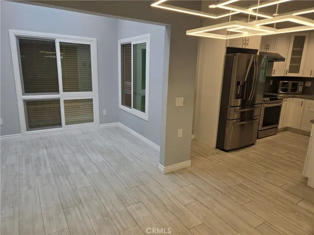Den/atrium adjacent to kitchen from dining area