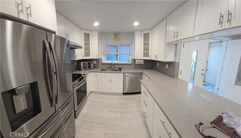 Kitchen with newer appliances, flooring and convenience