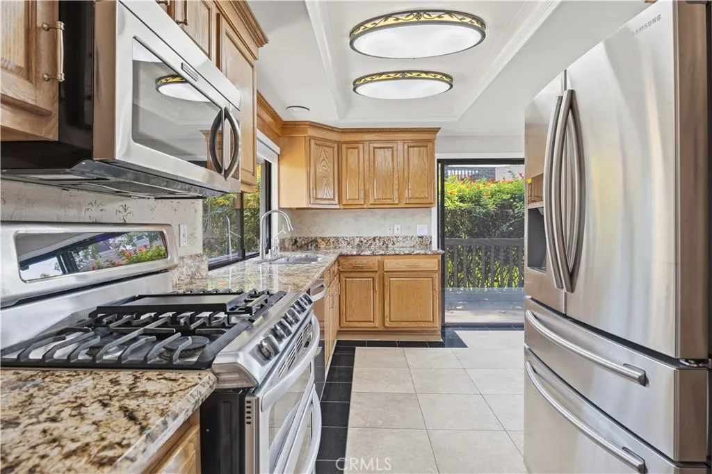 Another view of the kitchen with stainless steel appliances.