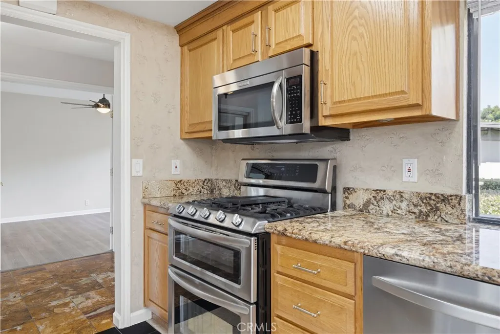 Refreshed kitchen cabinets doors and new handles. The room on the left side is the 2nd bedroom with its own bathroom.