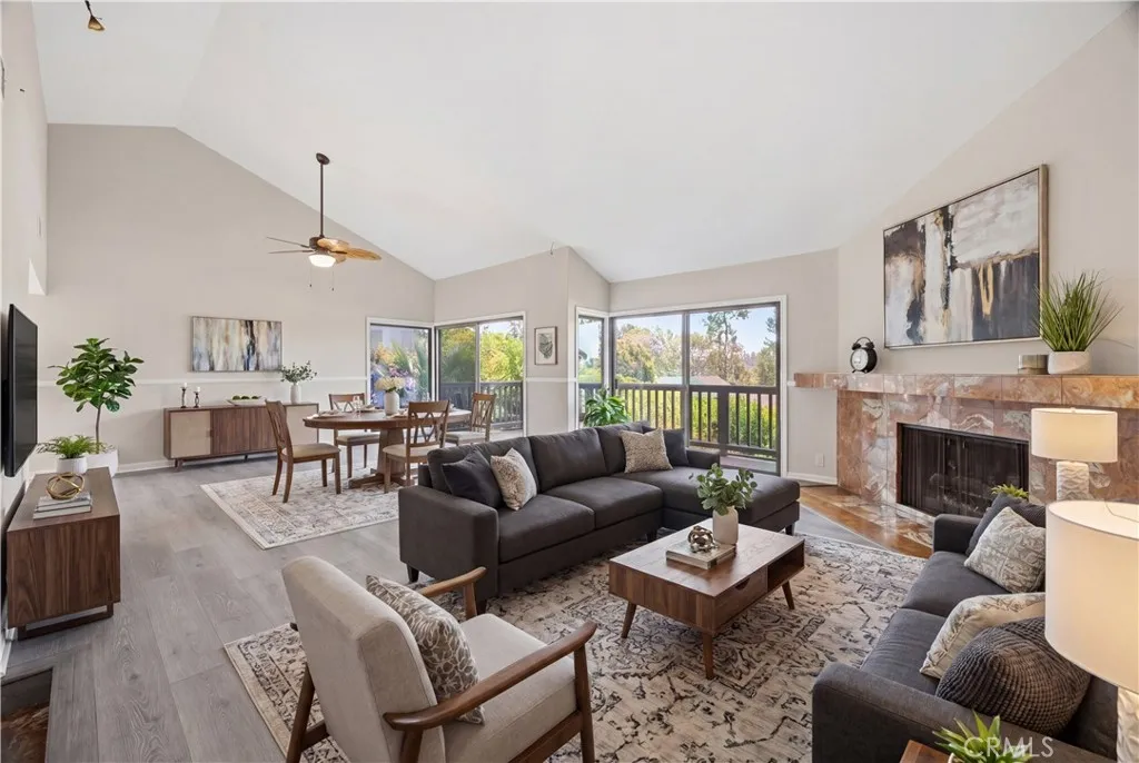 The light and bright living room and dining room with brand-new luxury floor, fresh paint and brand-new ceiling fan/light. Virtually staged.
