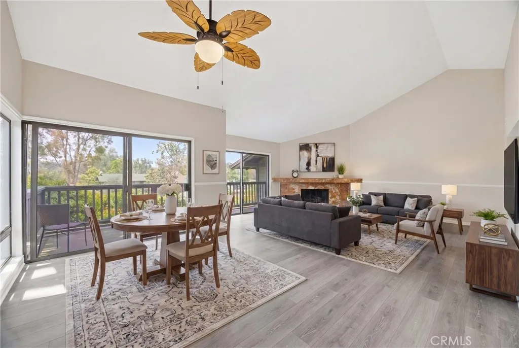 Another view of the dining room and living room with high ceiling, and two sets of sliding doors leads to the balcony with view of the blooming plants and very private.