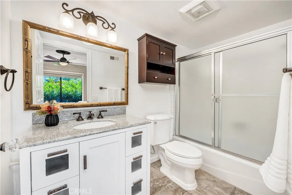 The secondary bathroom with shower and tub combo.