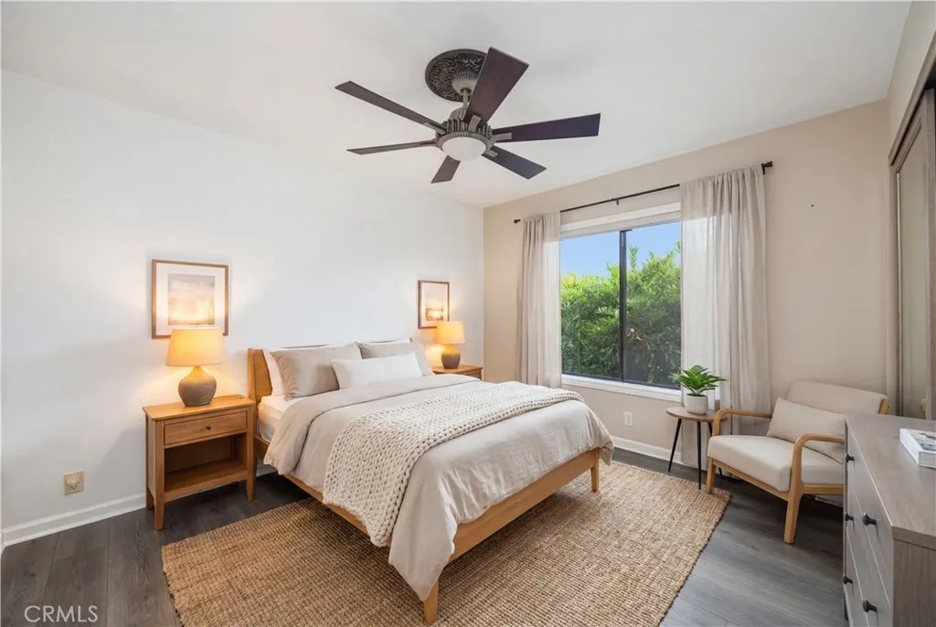 The second bedroom is freshly painted with virtual staging. The beautiful plants outside the window provide not only the privacy, but also create a calming environment.